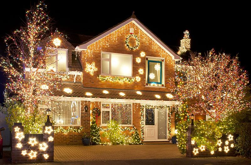 Elegant warm white Christmas light installation on luxury home